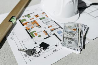 Home Floorplans with House Keys Sitting on Top