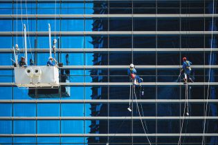 Maintenance Workers on the Side of a Commercial Highrise
