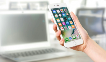 Close Up of a Hand Holding a Large White iPhone