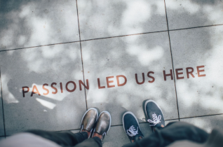 Passion Led Us Here Written on a Sidewalk