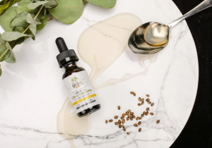 CBD Bottle and Hemp Seeds on a Plate