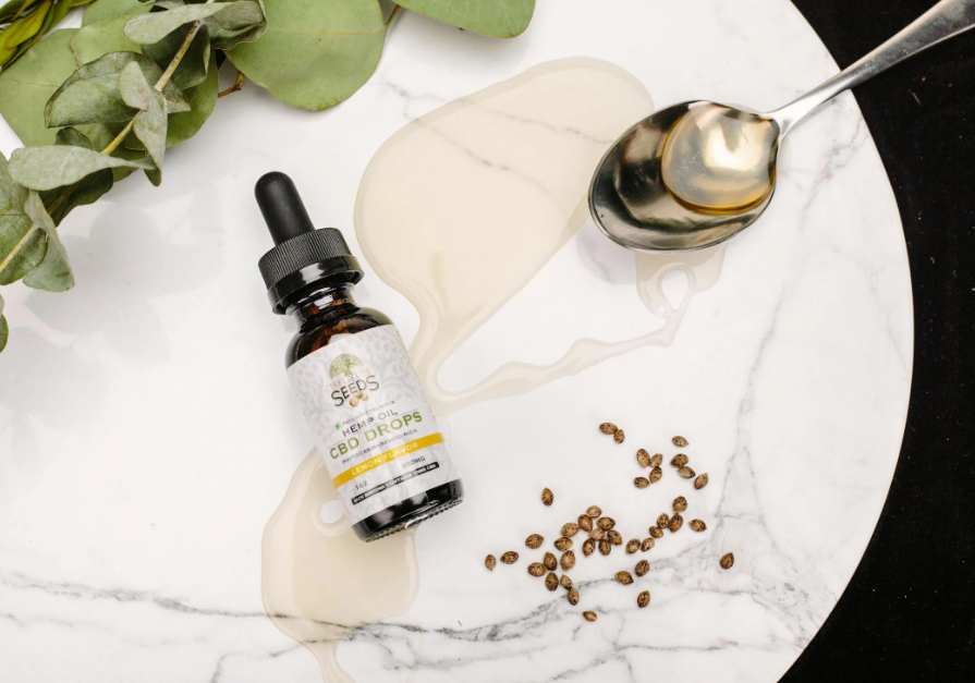 CBD Bottle and Hemp Seeds on a Plate
