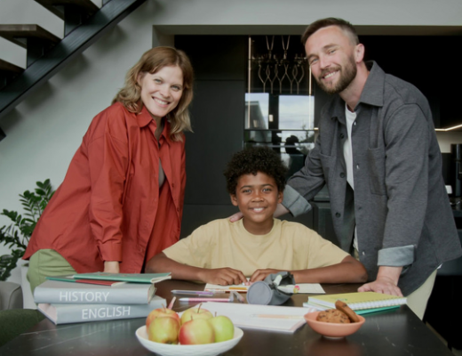 2 Parents Standing Beside an Adopted Child