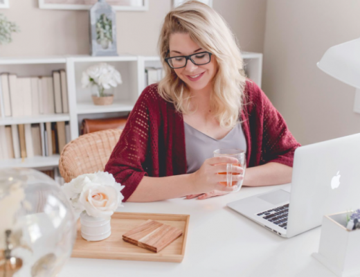 Blonde Woman Wearing Glasses and Sitting at a Desk