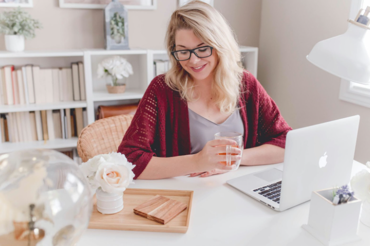 Blonde Woman Wearing Glasses and Sitting at a Desk