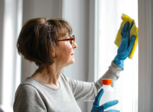 Older Woman Cleaning a Window