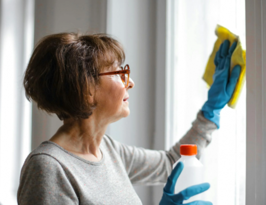 Older Woman Cleaning a Window