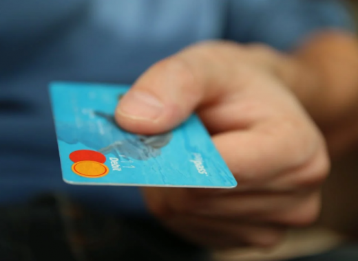 Close Up of a Hand Holding a Blue Mastercard