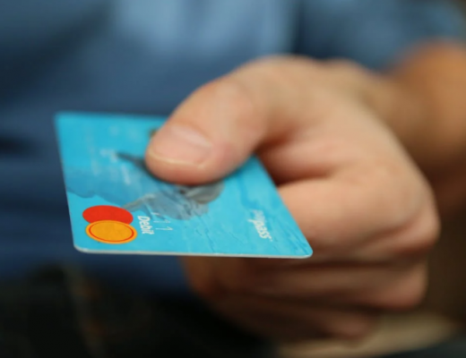 Close Up of a Hand Holding a Blue Mastercard