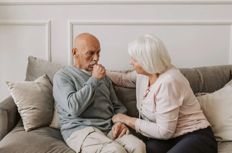 Elderly Woman Comforting Sick Elderly Man