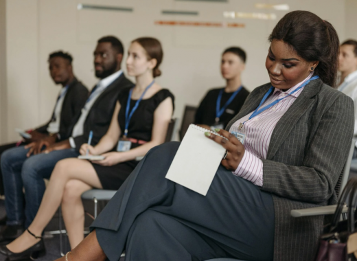 Diverse Group of People Attending a Small Conference