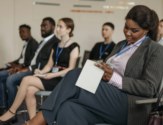Diverse Group of People Attending a Small Conference