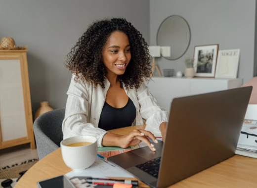 Smiling African American Woman Typing on a Laptop