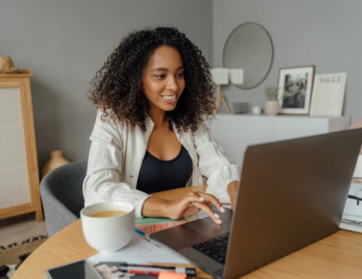 Smiling African American Woman Typing on a Laptop