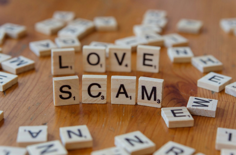 Love and Scam Written in Scrabble Tiles