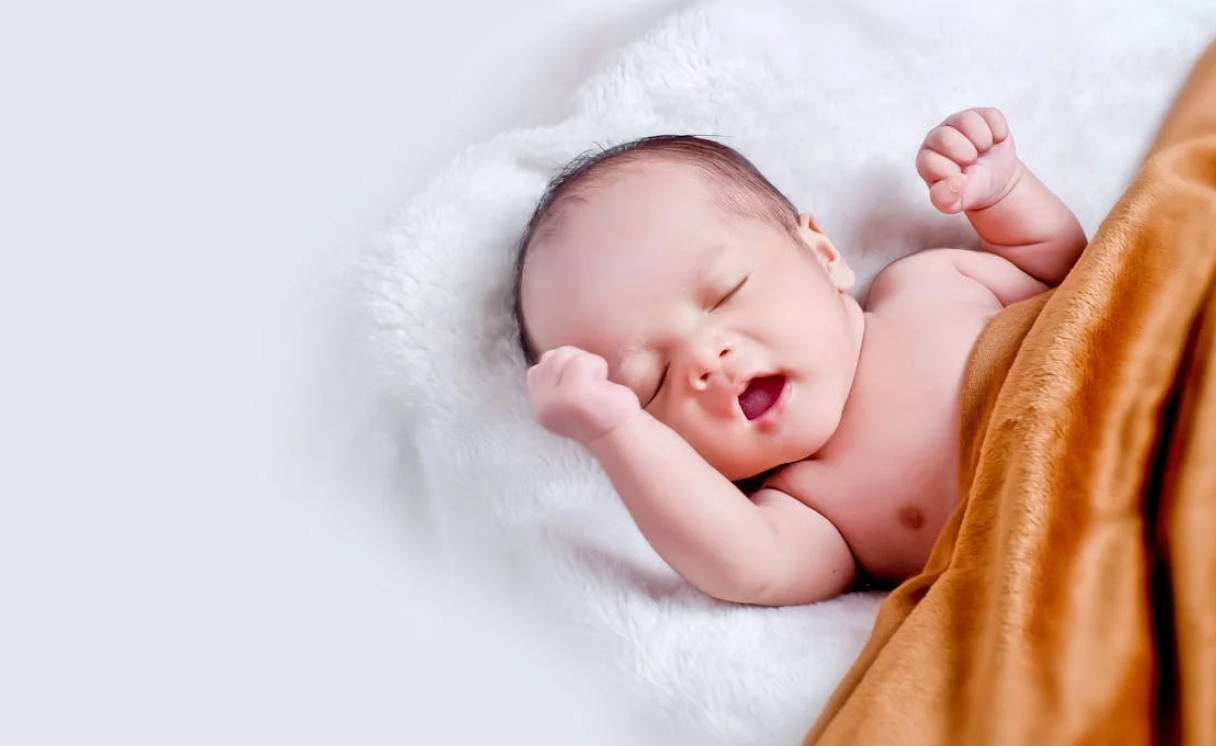 Sleeping Baby Wrapped in Mustard Yellow Blanket