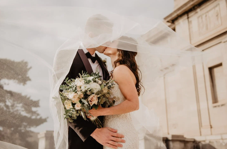 Young Man and Woman Kissing at Their Wedding