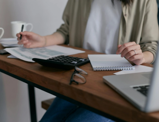 Woman Sitting at a Desk and Balancing Her Bank Account