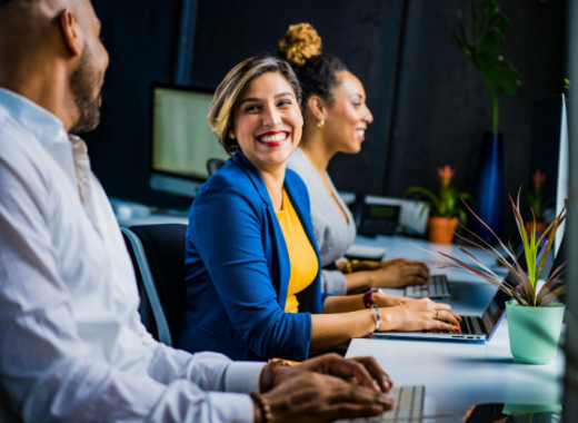 Smiling Woman Sitting in a Conference Room