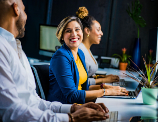 Smiling Woman Sitting in a Conference Room