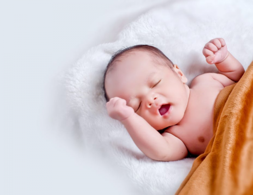 Yawning Baby Wrapped in Orange Blanket