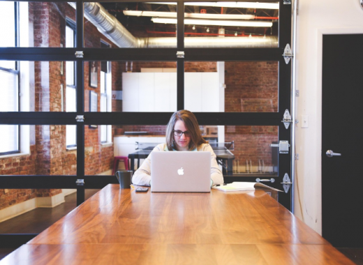 Woman Sitting at a Desk In An Office