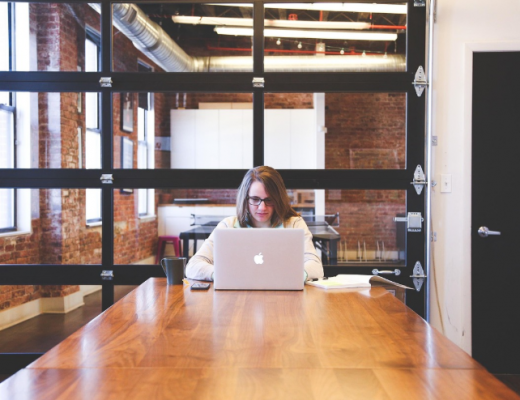 Woman Sitting at a Desk In An Office
