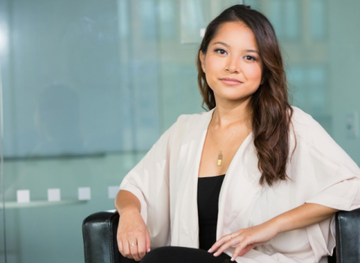 Business Woman with Long Brown Hair Posed in Office Chair