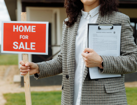 Female Realtor Holding for Sale Sign