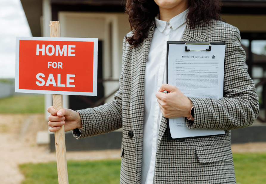 Female Realtor Holding for Sale Sign