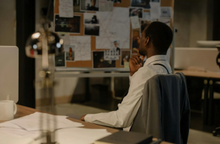 Investigator Looking at His Notes on the Wall