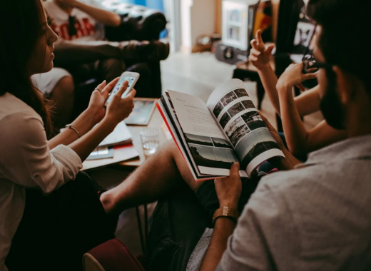 Group of People Sitting Around a Conference Room Table