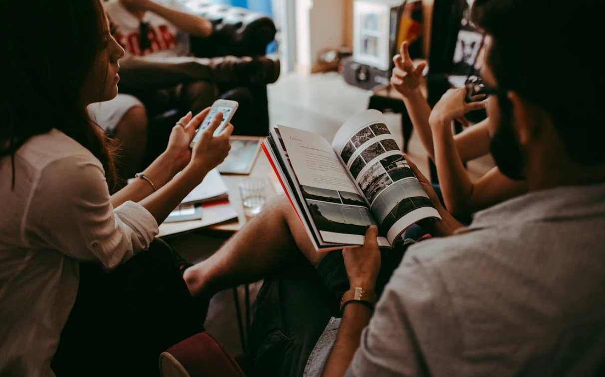 Group of People Sitting Around a Conference Room Table