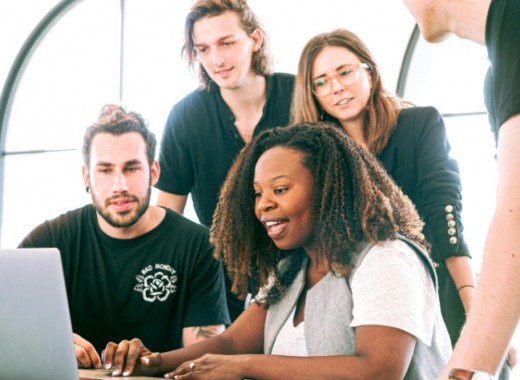 Diverse Group of 4 People Looking at a Computer Screen