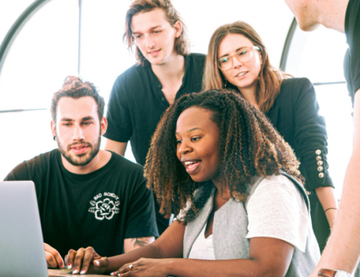 Diverse Group of 4 People Looking at a Computer Screen