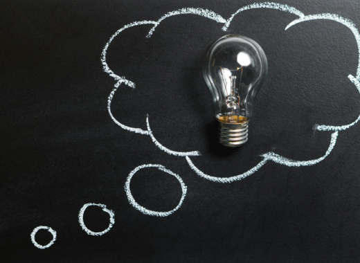 Lightbulb Surrounded by a Cloud Drawn on a Chalkboard