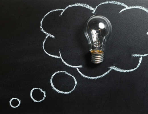 Lightbulb Surrounded by a Cloud Drawn on a Chalkboard
