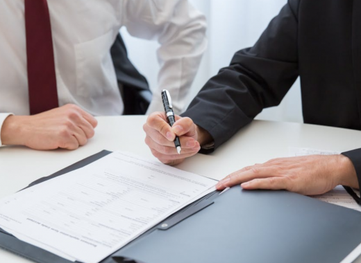 Business Person Signing Paperwork