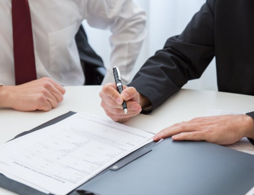 Business Person Signing Paperwork