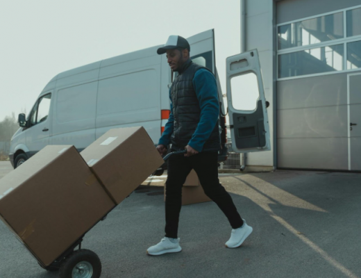 Man Pushing Moving Boxes on a Dolly