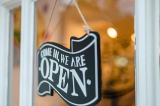 Come In, We're Open Sign Hanging on Storefront Door