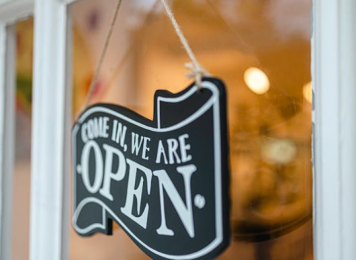 Come In, We're Open Sign Hanging on Storefront Door