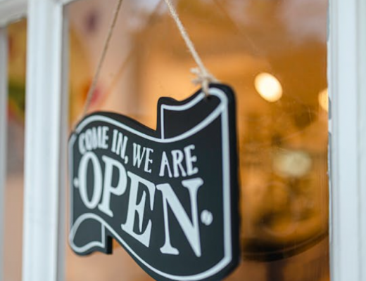 Come In, We're Open Sign Hanging on Storefront Door