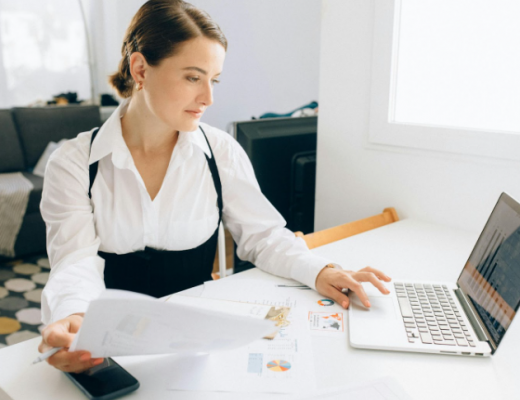 Caucasian Business Woman Sitting at a Desk and Working on a Laptop