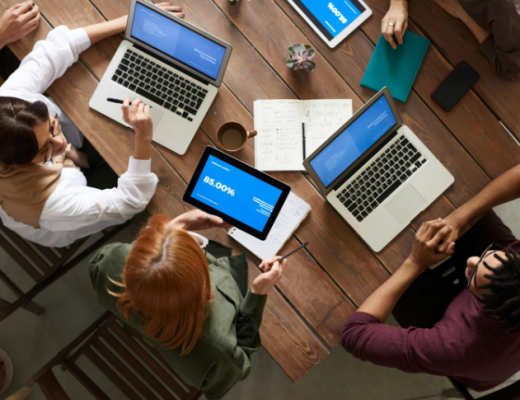 Aerial View of 4 Laptops on a Conference Table
