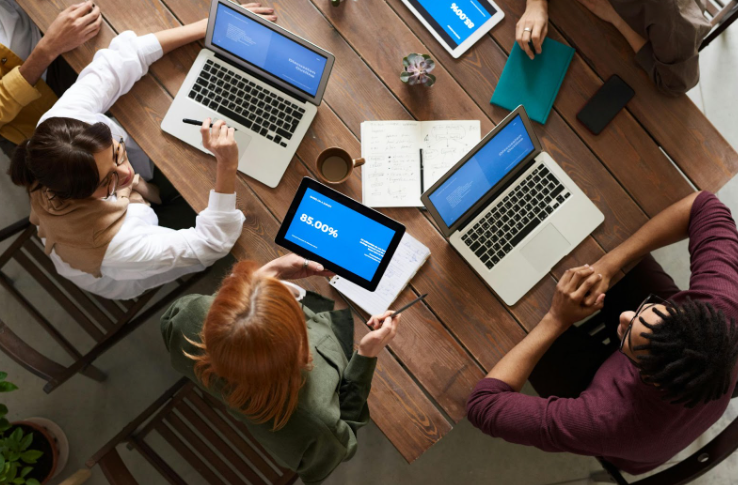 Aerial View of 4 Laptops on a Conference Table