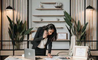 Female Attorney Standing at Her Desk on the Phone
