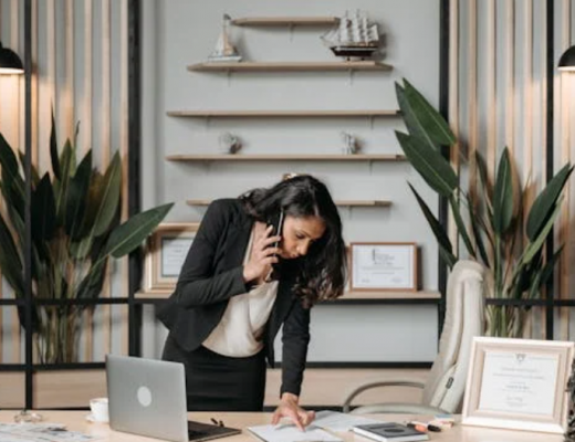 Female Attorney Standing at Her Desk on the Phone