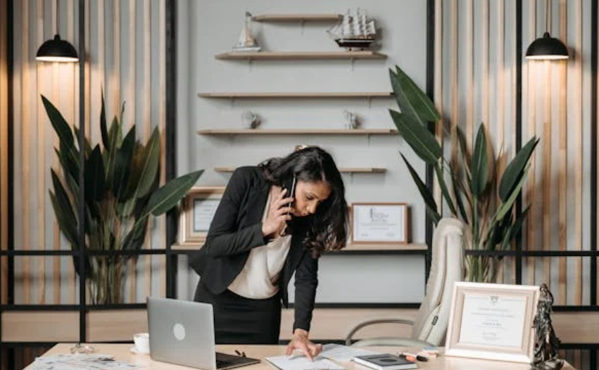 Female Attorney Standing at Her Desk on the Phone