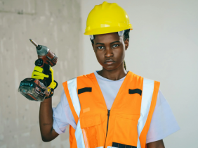 Female African American Construction Worker Holding a Drill